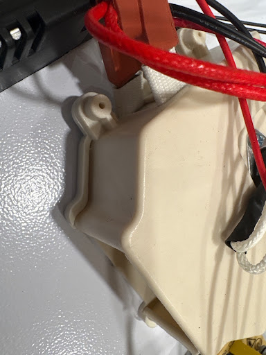 Snap-switch / thermostat area — the little metal liar