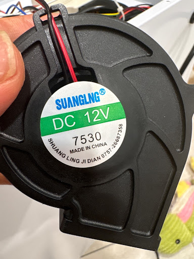 Stock-era 12V 7530 label — politely useless CFM